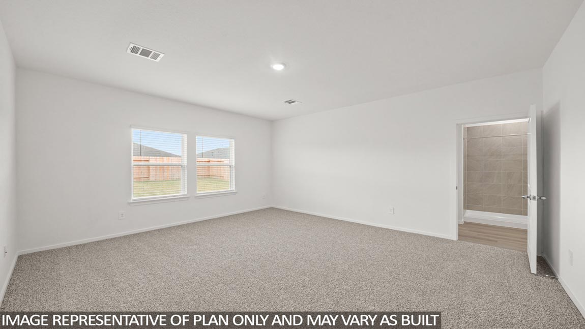 Primary bedroom with carpet flooring