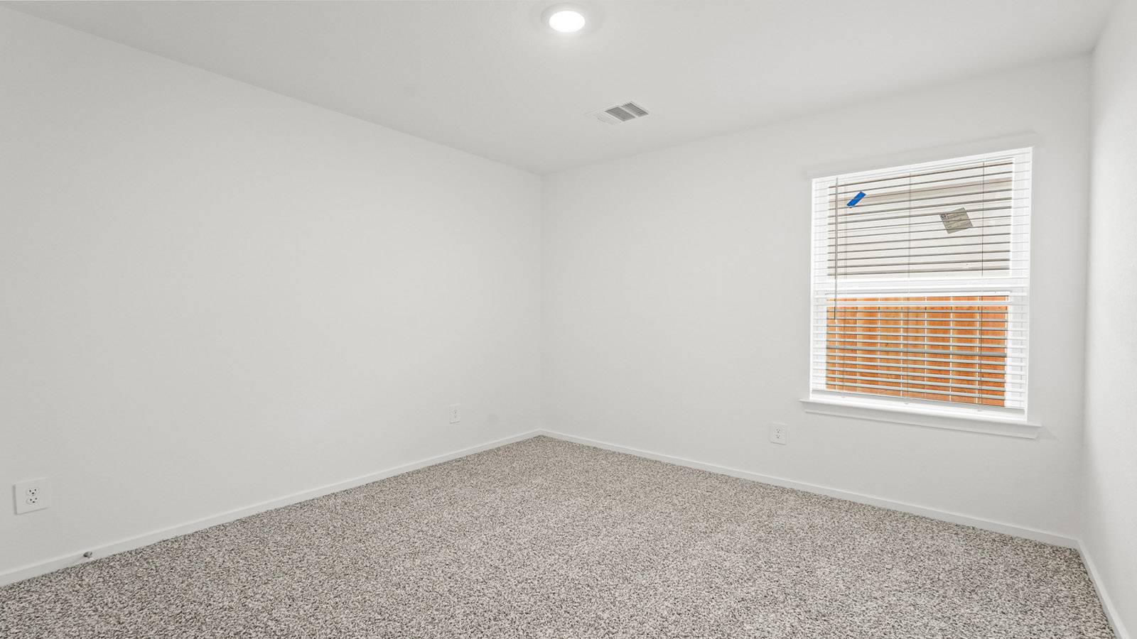Secondary bedroom with carpet flooring