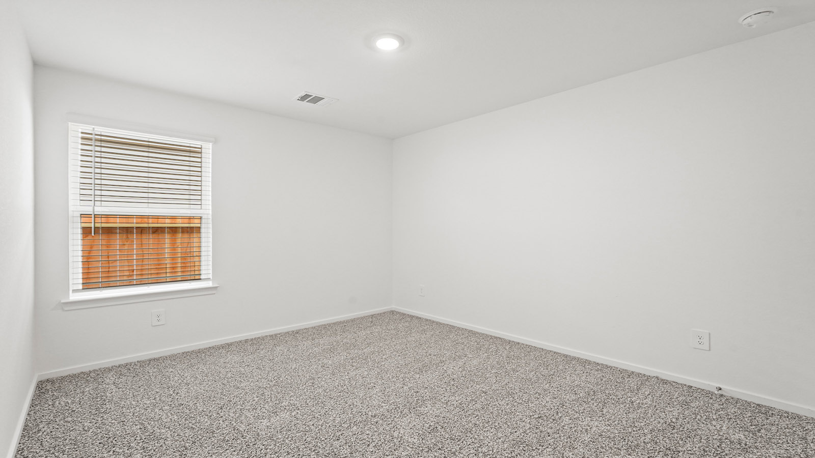 Secondary bedroom with carpet flooring