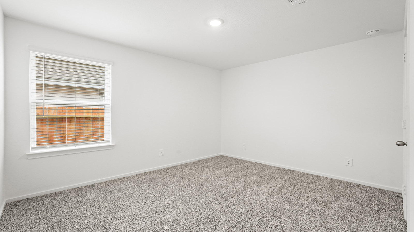 Secondary bedroom with carpet flooring