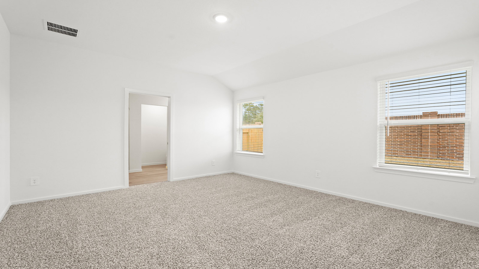 Primary bedroom with bright windows