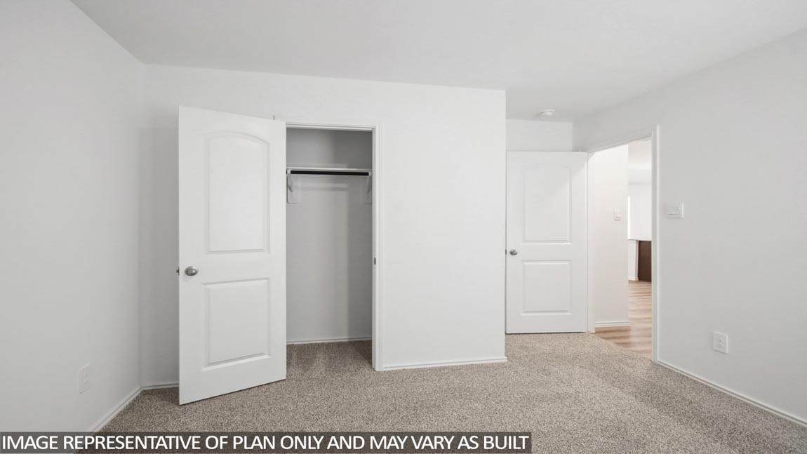 Secondary bedroom with carpet flooring