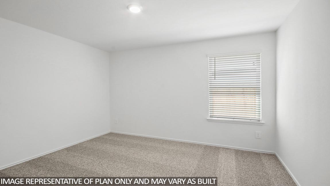 Secondary bedroom with carpet flooring