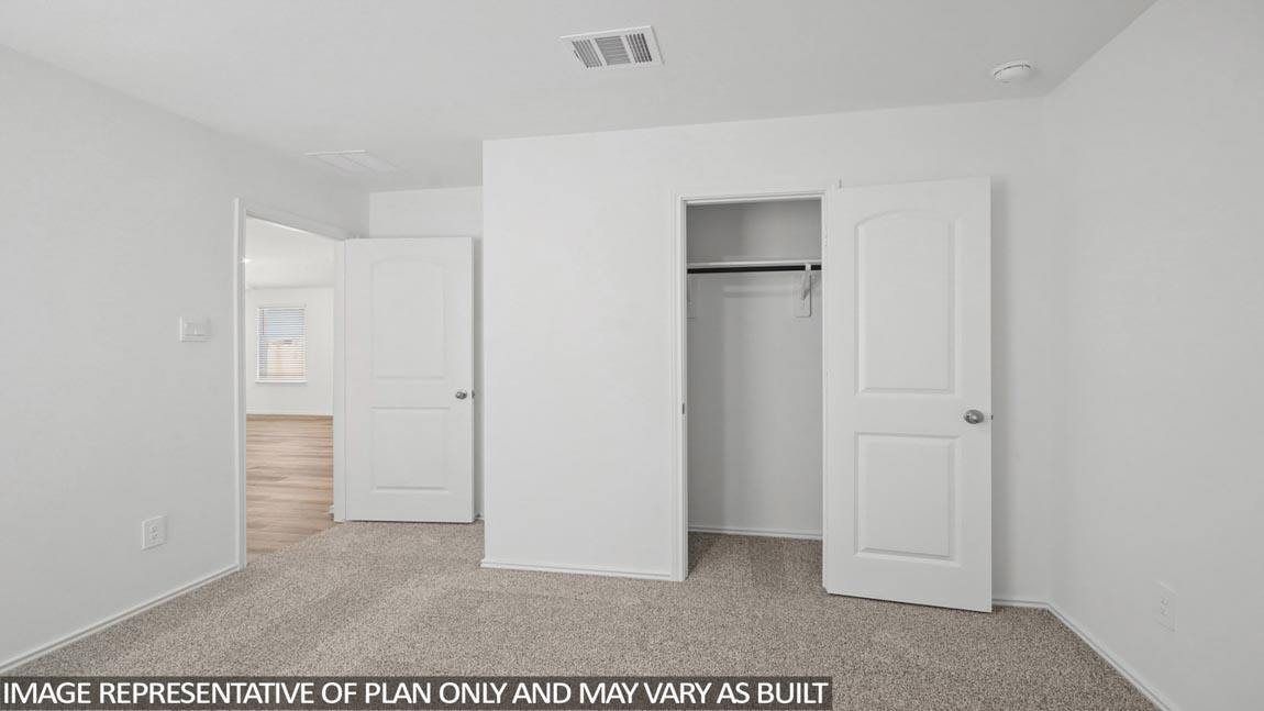 Secondary bedroom with carpet flooring