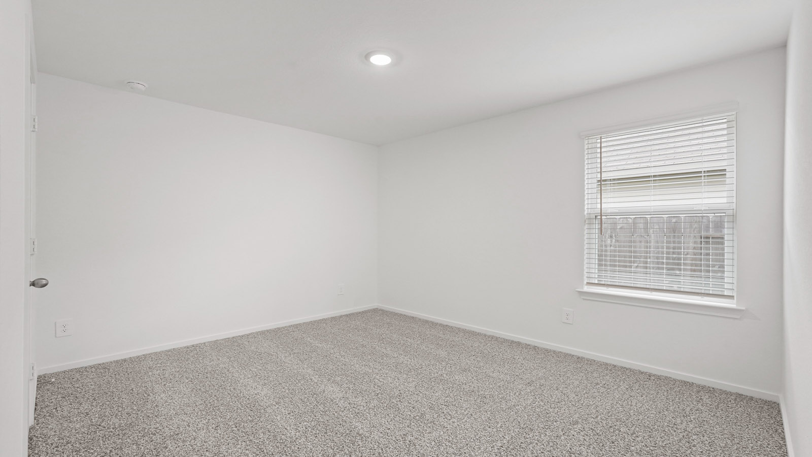 Secondary bedroom with carpet flooring