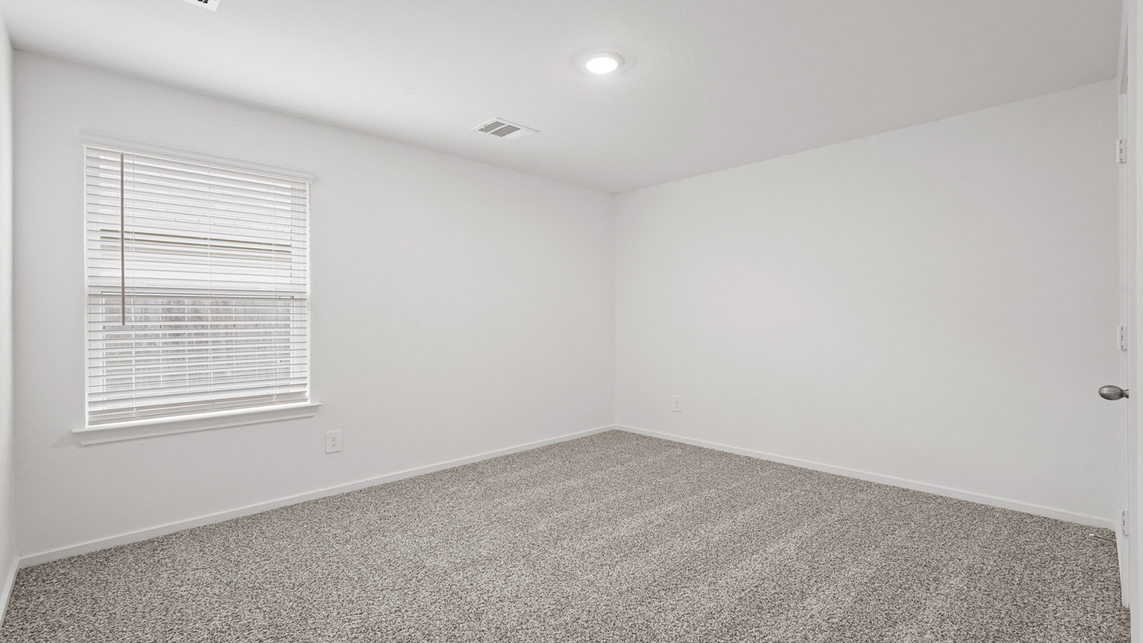 Secondary bedroom with carpet flooring