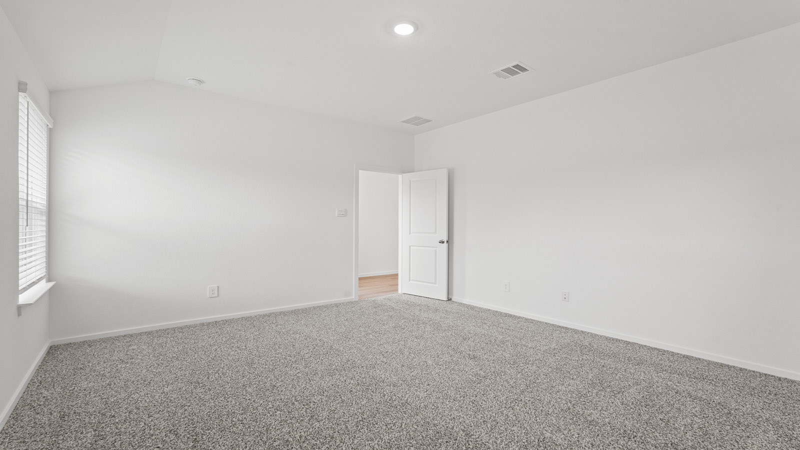 Primary bedroom with bright windows