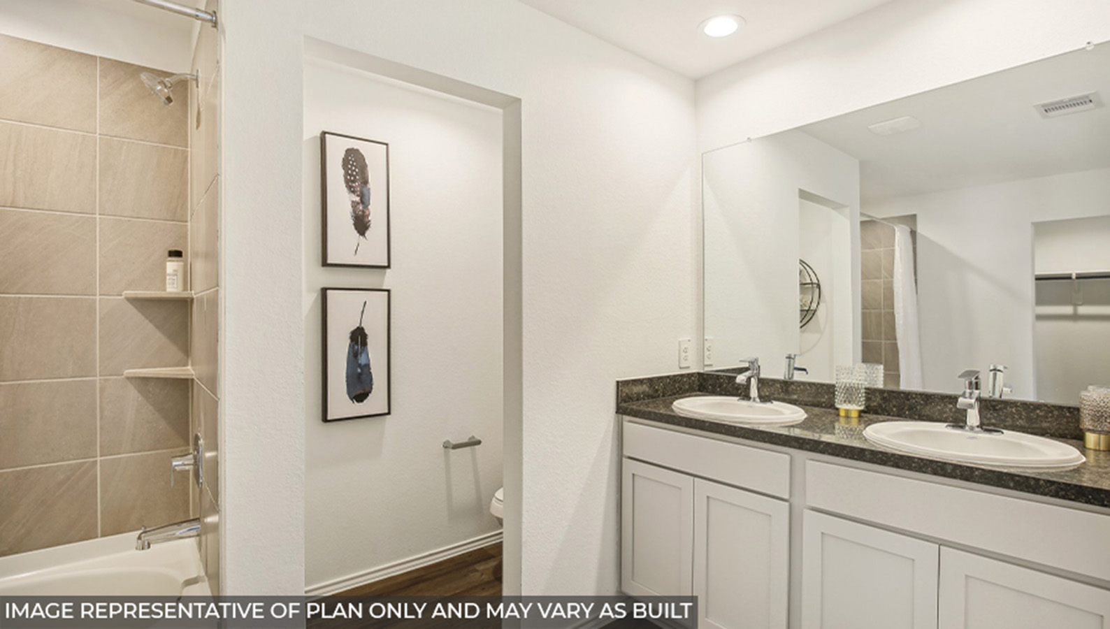 Primary bathroom with a double sink and a separate toilet room.