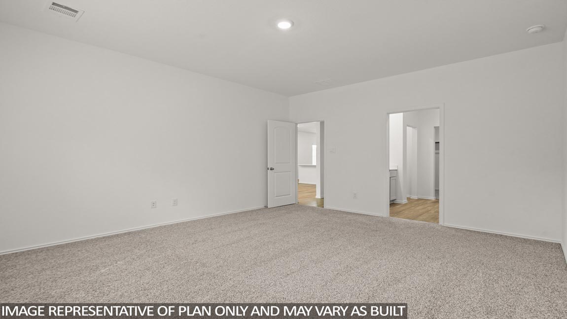 Primary bedroom with carpet flooring