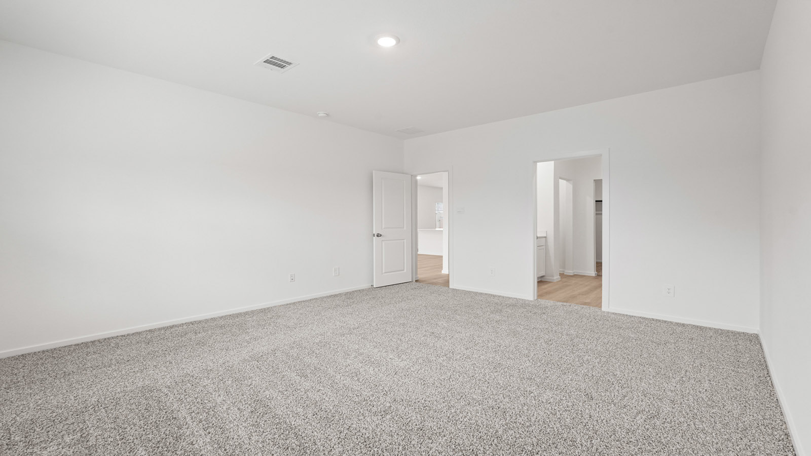 Primary bedroom with carpet flooring
