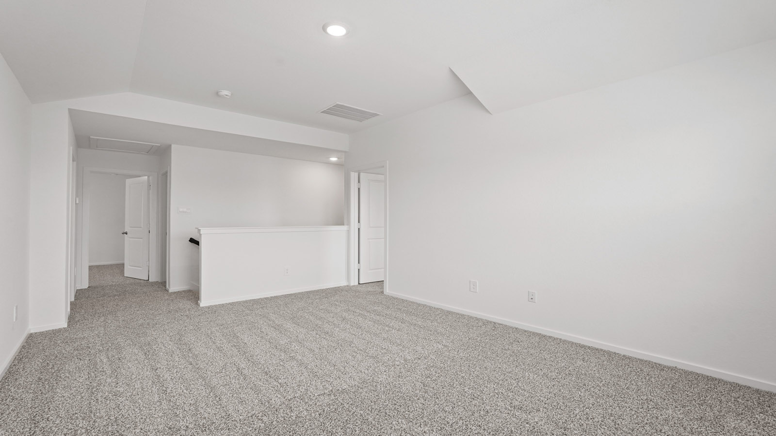 Second story game room with carpet flooring