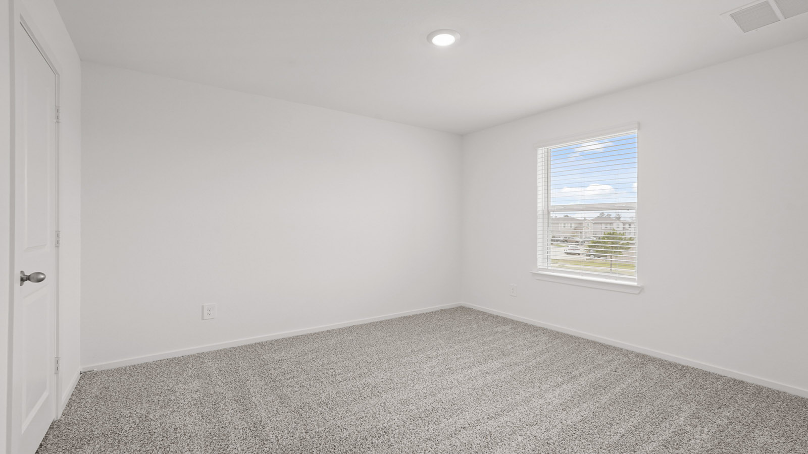 Secondary bedroom with carpet flooring