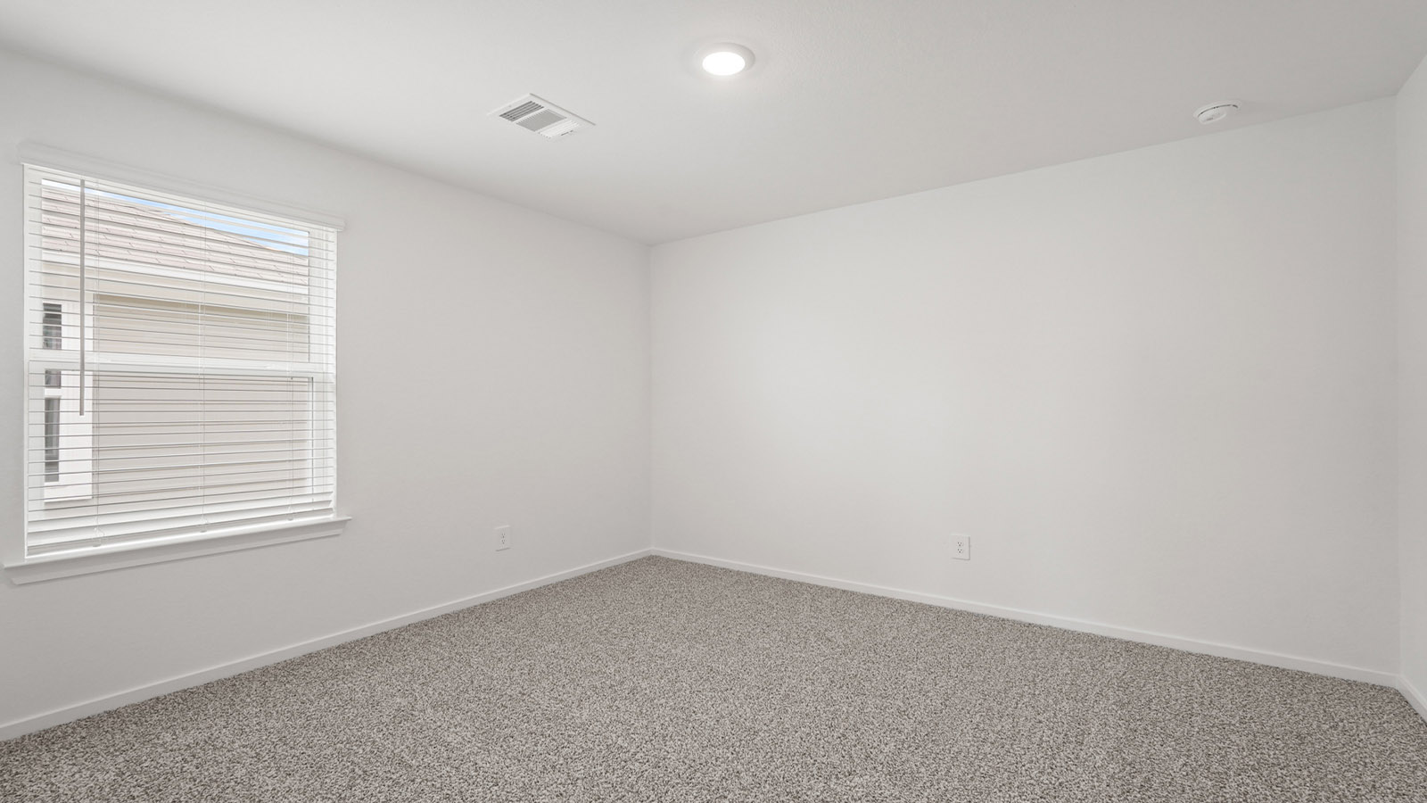 Secondary bedroom with carpet flooring