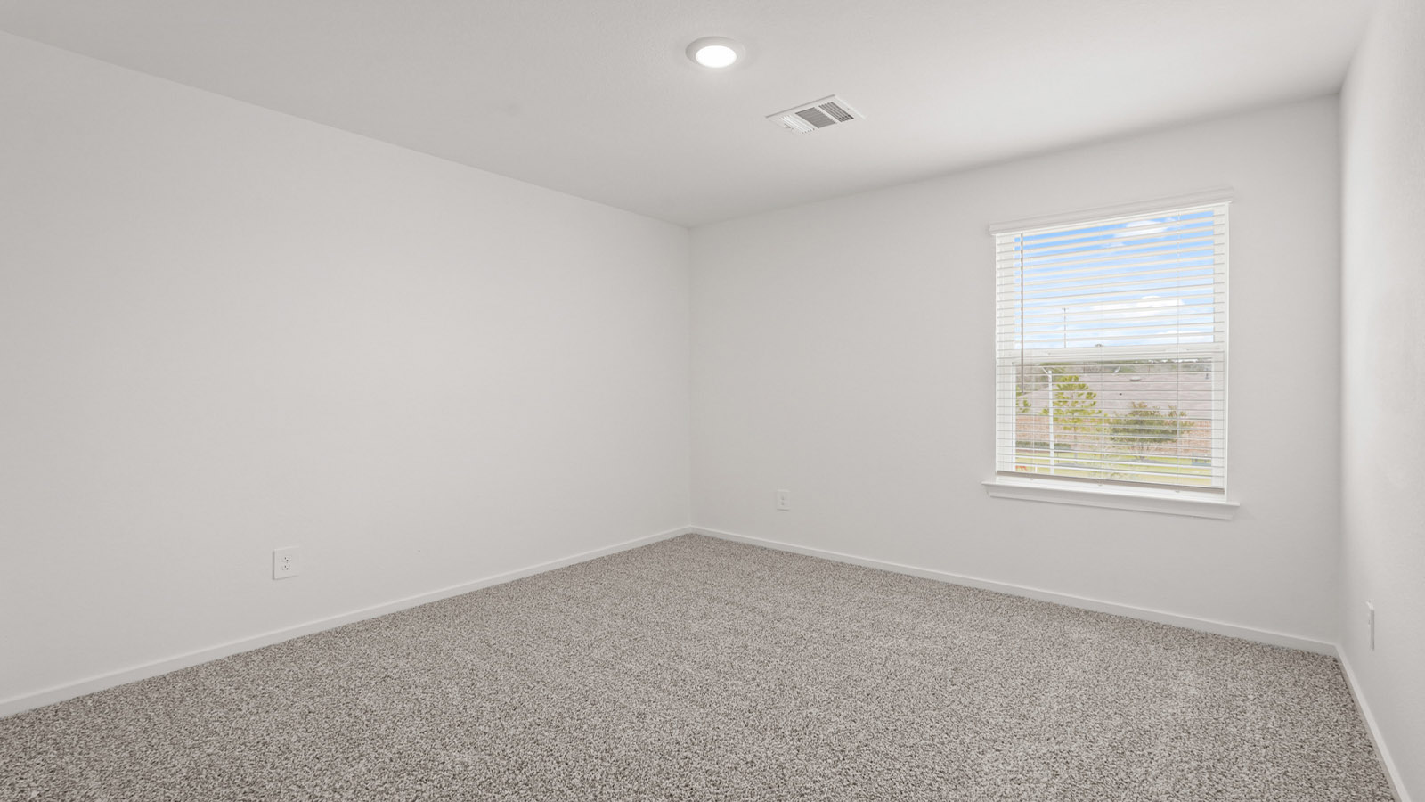 Secondary bedroom with carpet flooring