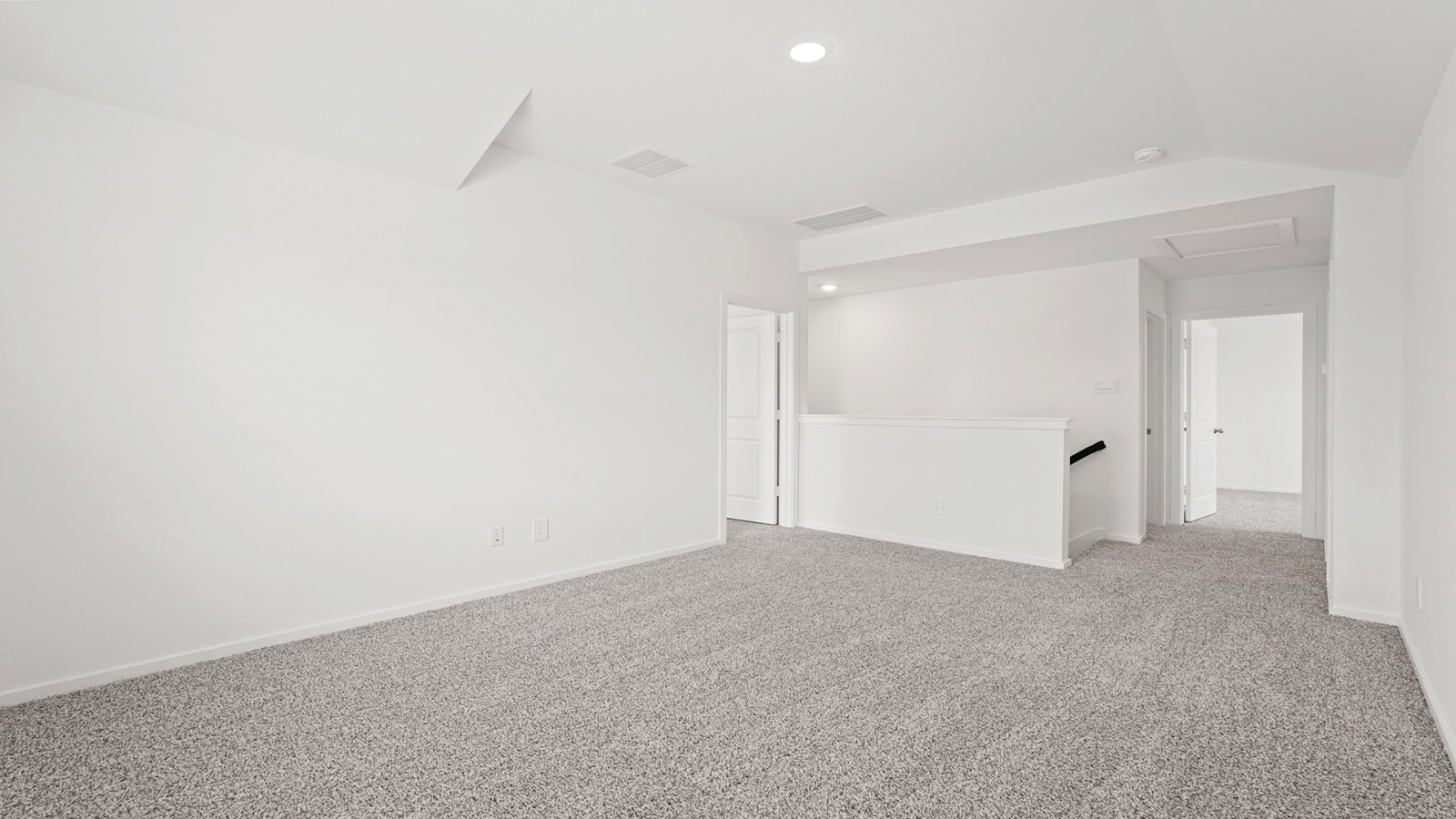 Second story game room with carpet flooring