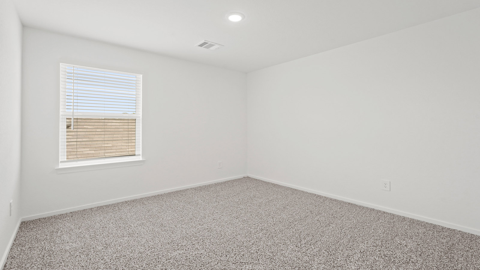 Secondary bedroom with carpet flooring