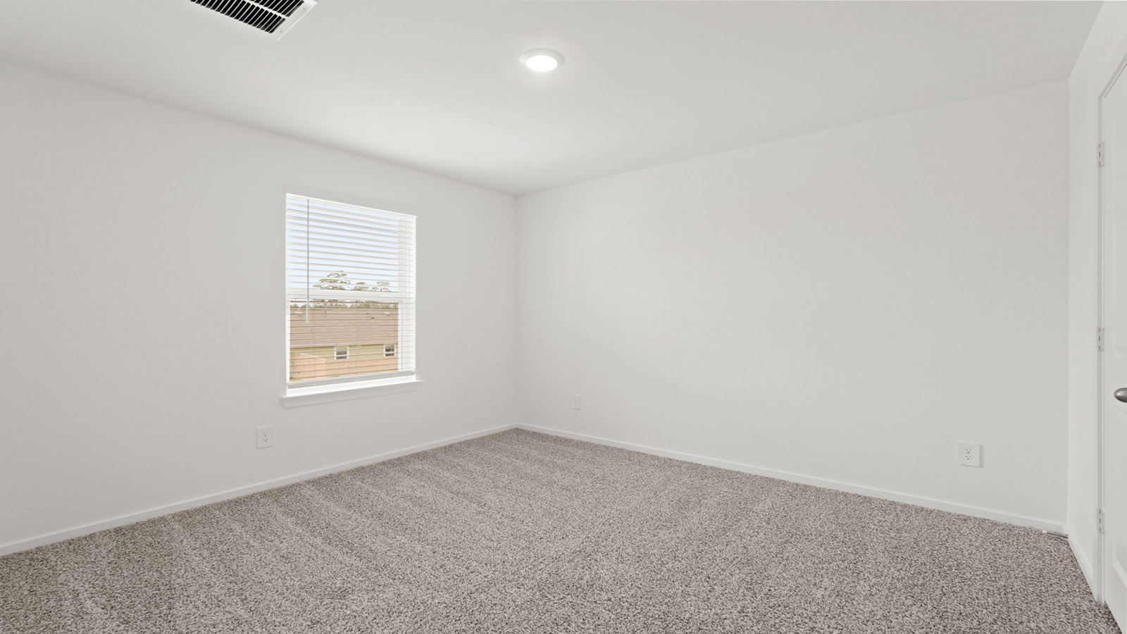 Secondary bedroom with carpet flooring