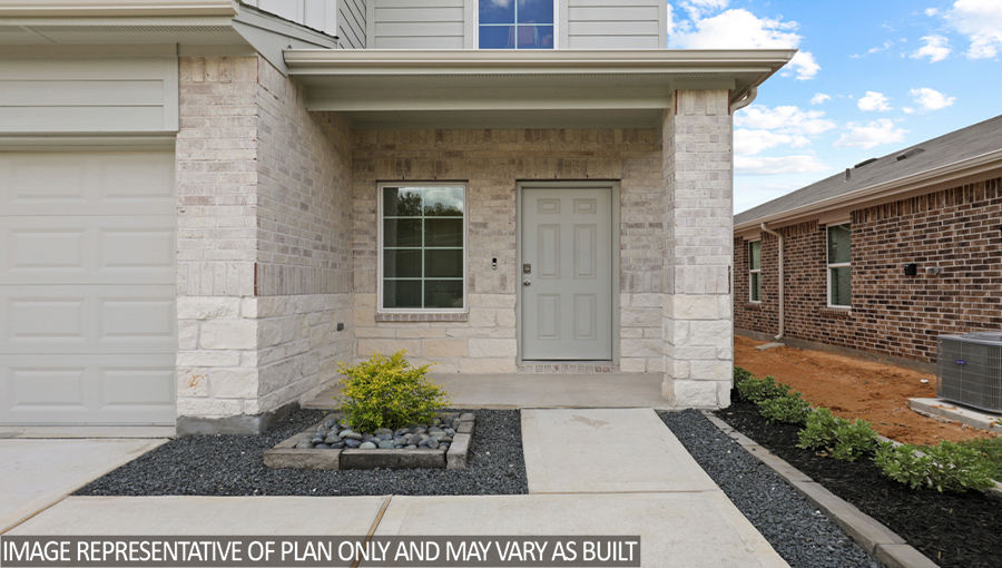 Two-story home with tan trim and a two-car garage.