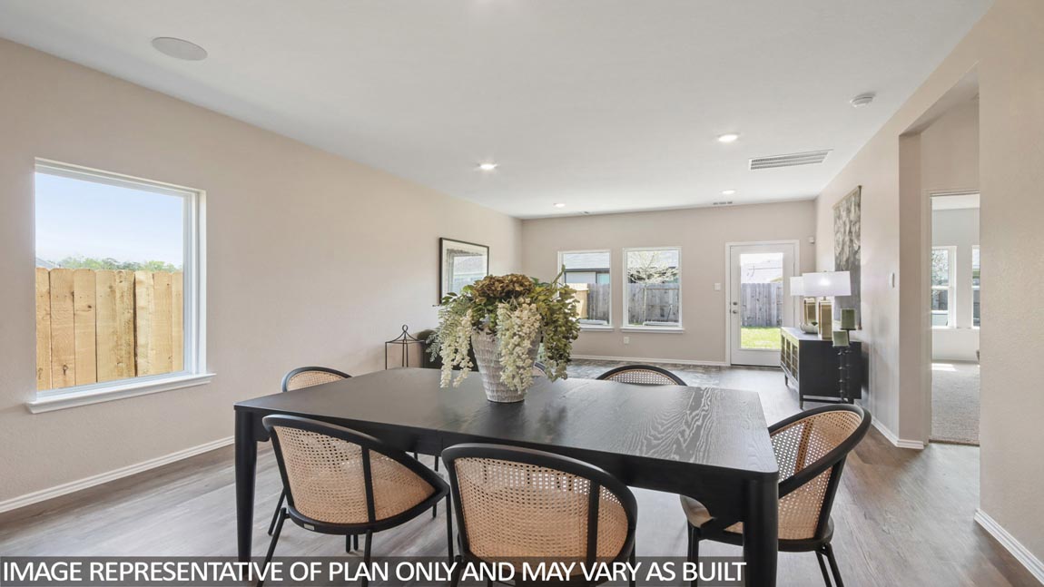 Open concept living and dining room with vinyl flooring and bright windows.