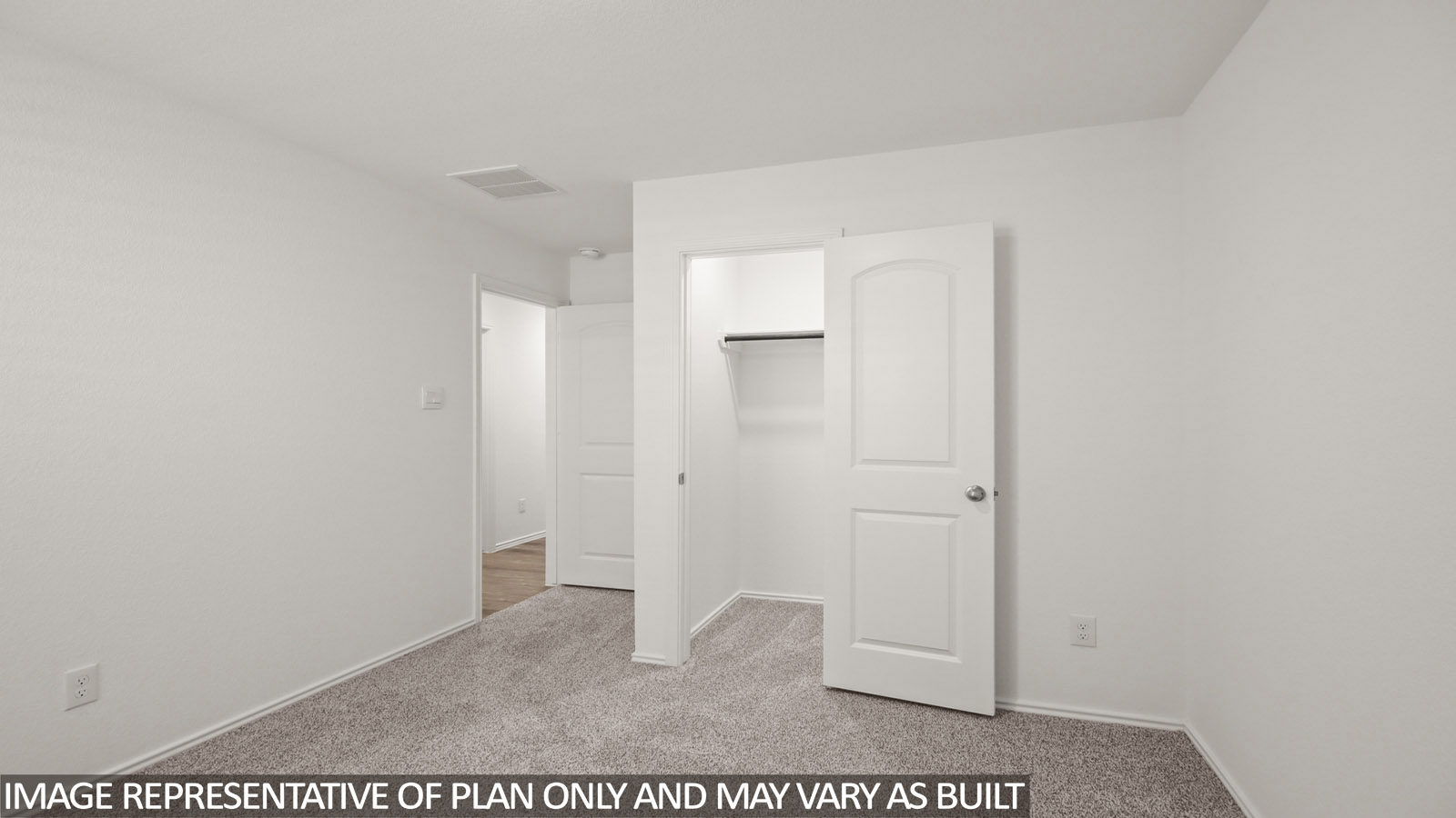 Secondary bedroom with carpet flooring