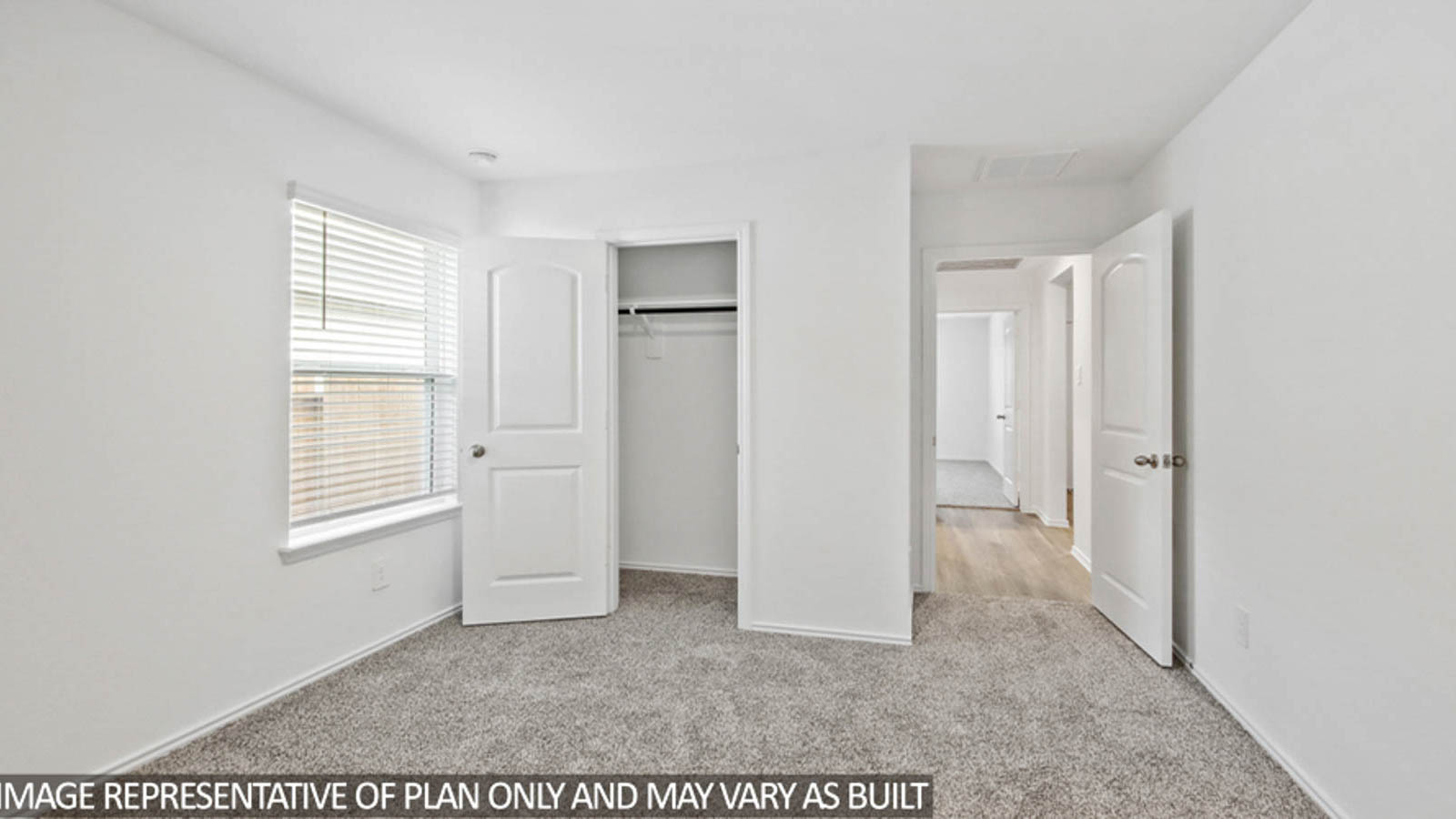 Secondary bedroom with carpet flooring and a bright window.