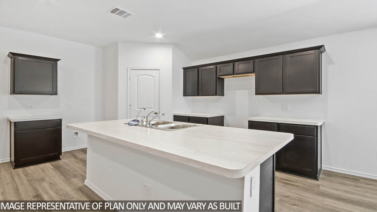 Kitchen with island and a tall pantry.