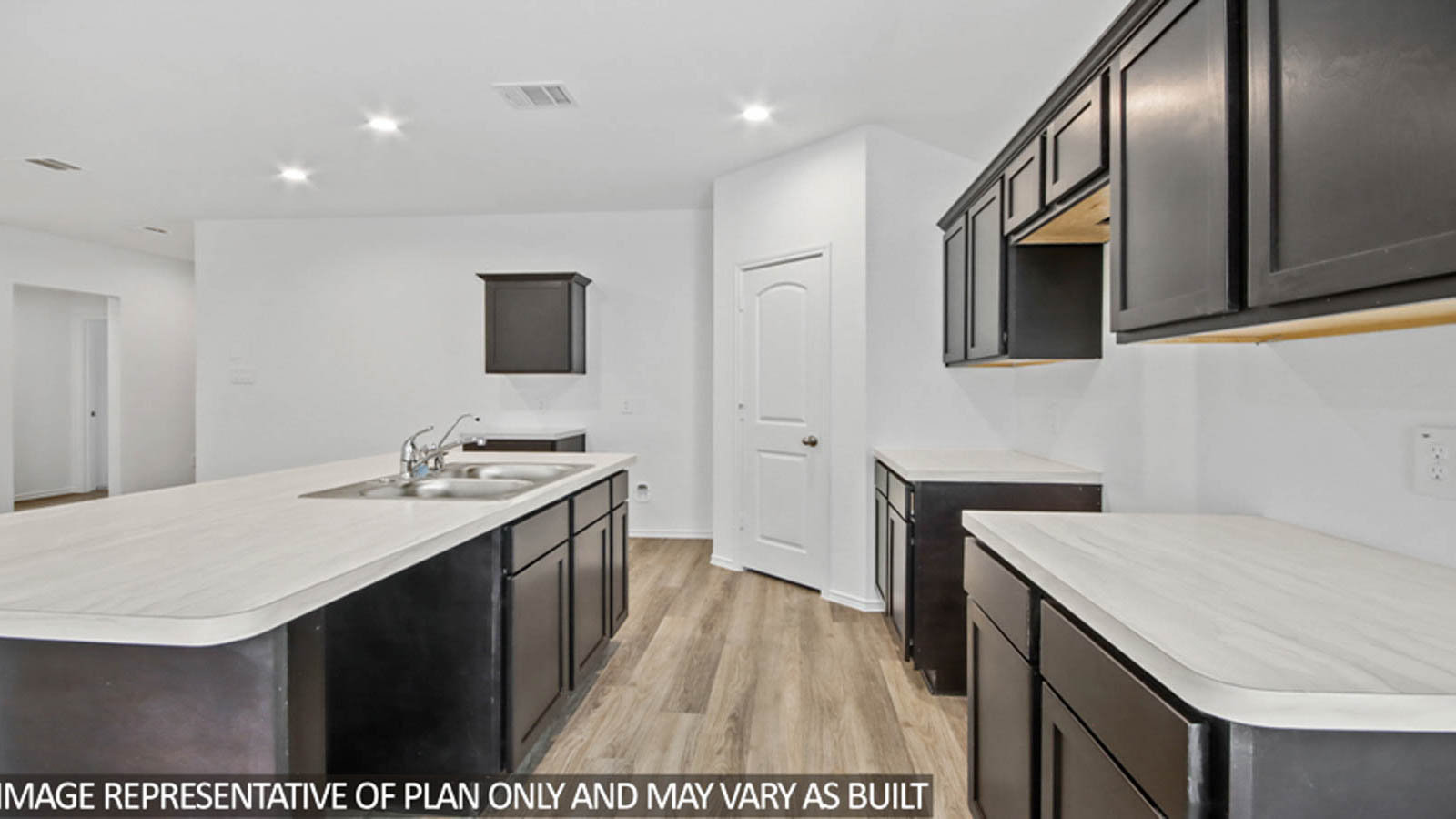 Kitchen with island and a tall pantry.