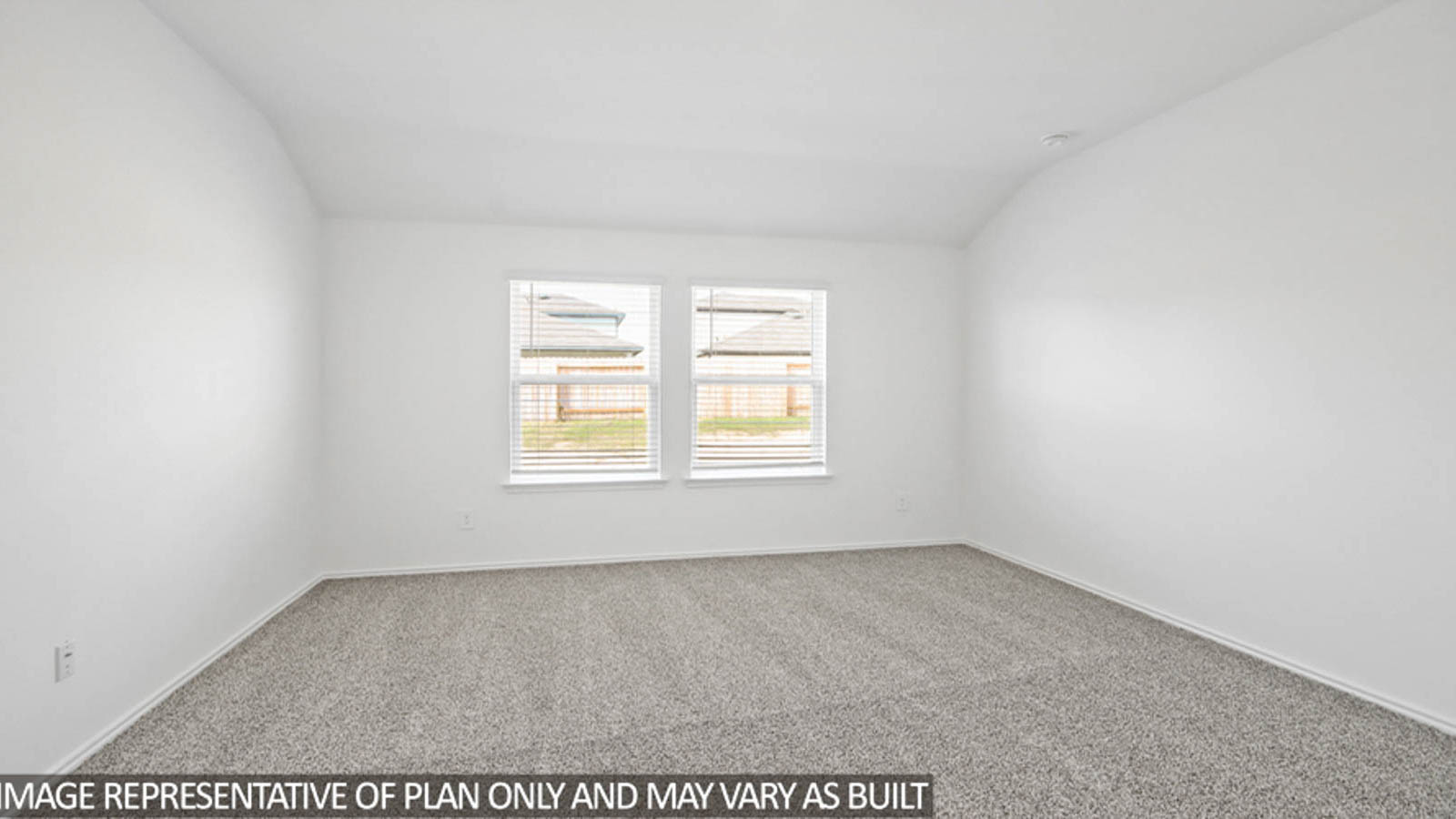 Primary bedroom with carpet flooring and bright windows.