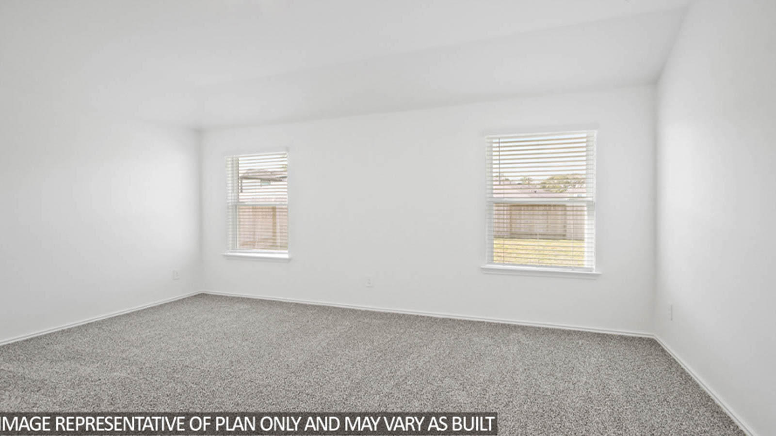 Primary bedroom with carpet flooring and bright windows.