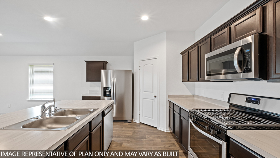 Kitchen with island and stainless-steel appliances.