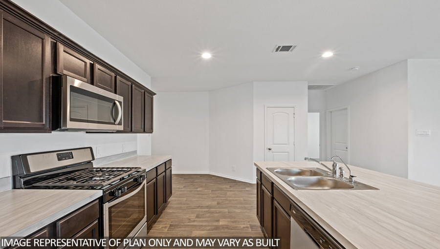 Kitchen with island and stainless-steel appliances.