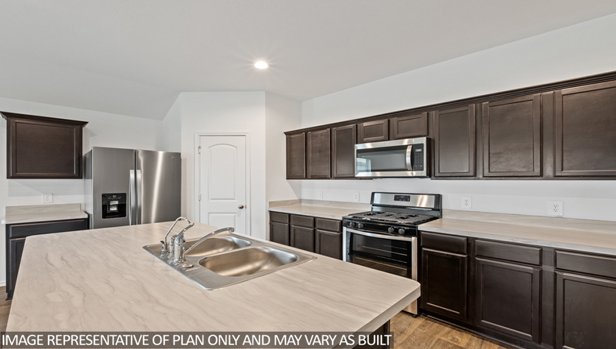 Kitchen with island and stainless-steel appliances.