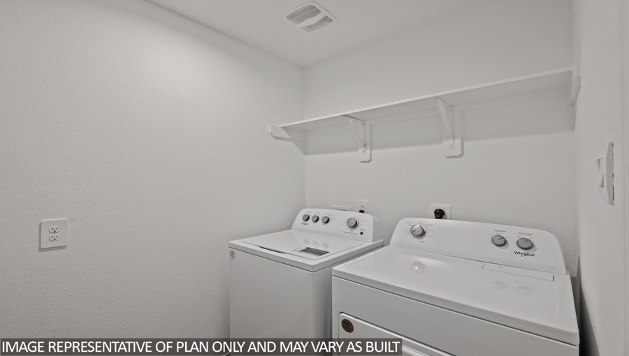 Utility room with overhead storage space.