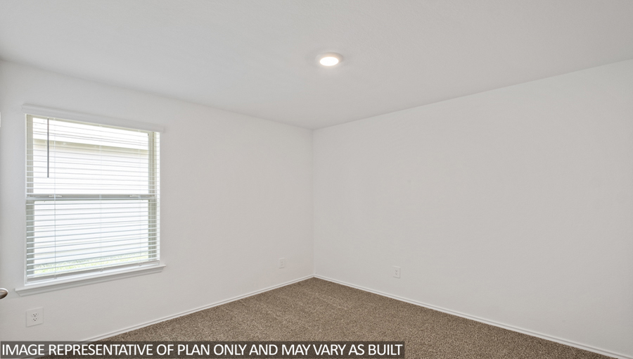 Secondary bedroom with carpet flooring and a bright window.