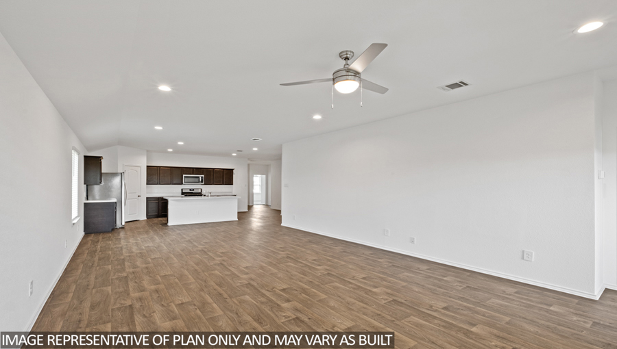 Open concept living and dining area with vinyl flooring.
