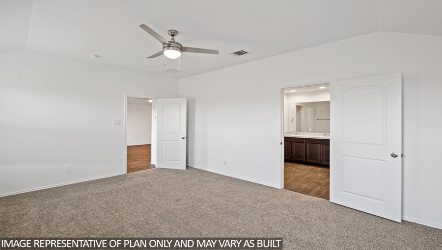 Primary bedroom with carpet flooring and a ceiling fan.