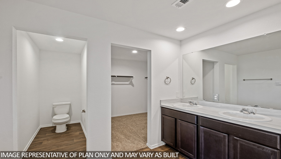 Primary bathroom with a separate toilet room and a walk-in closet.