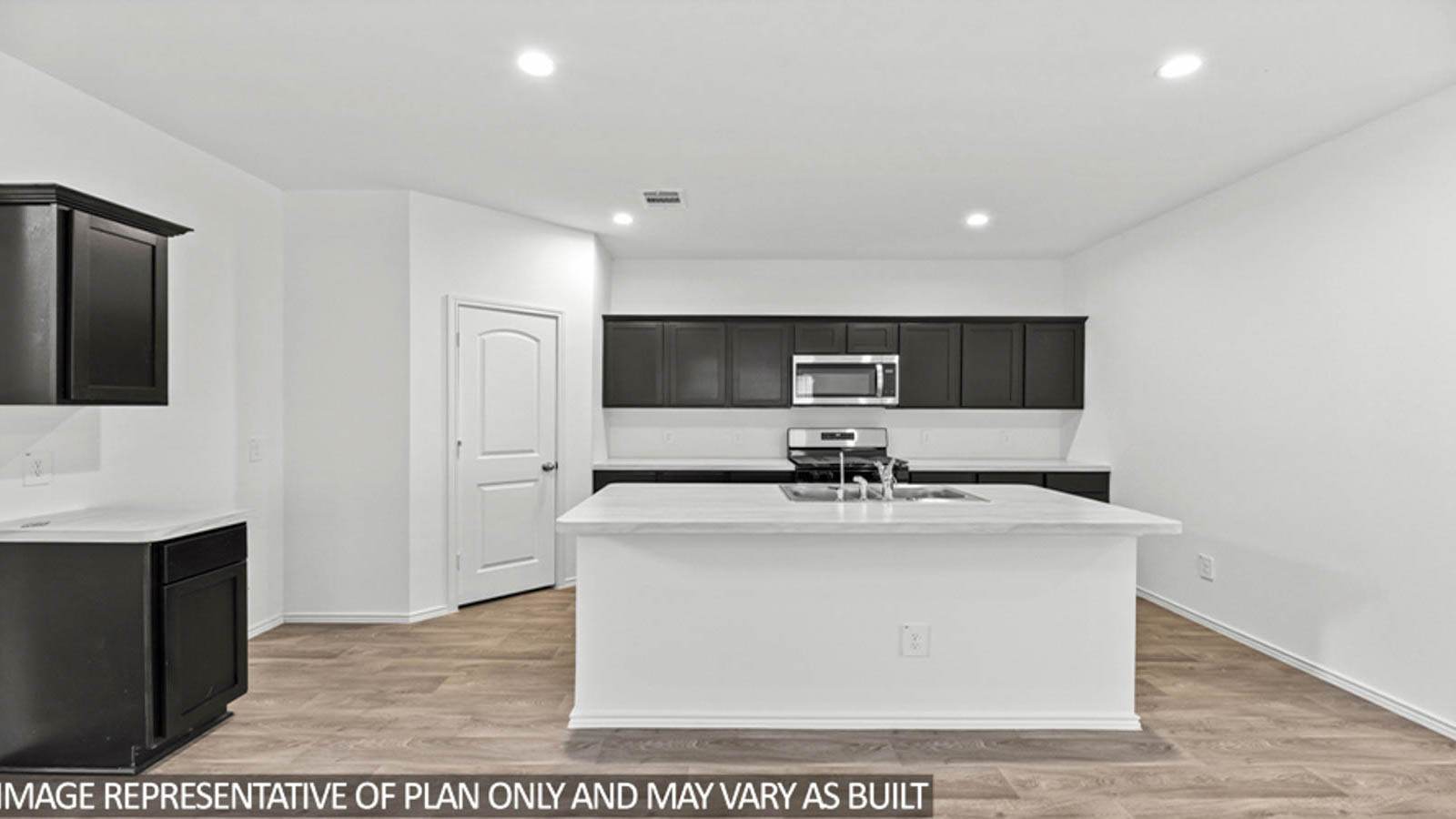 Kitchen with island and stainless-steel appliances.