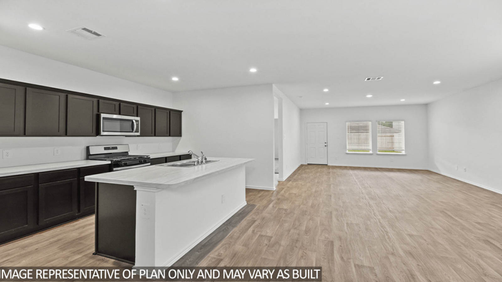 Kitchen with island and stainless-steel appliances.