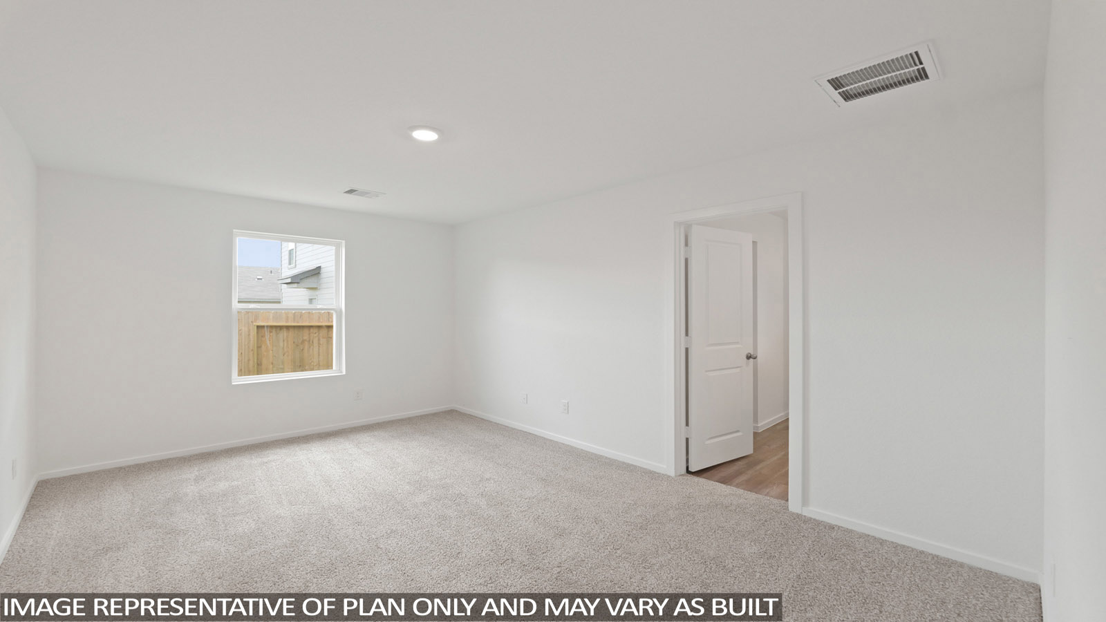 Secondary bedroom with carpet flooring
