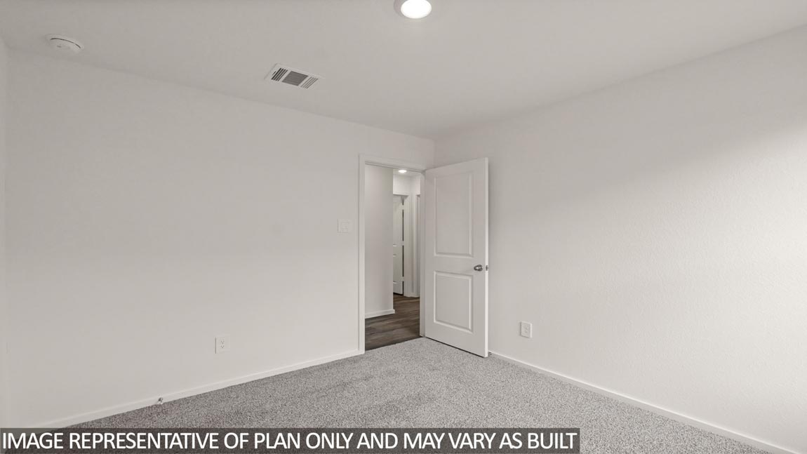 Secondary bedroom with carpet flooring