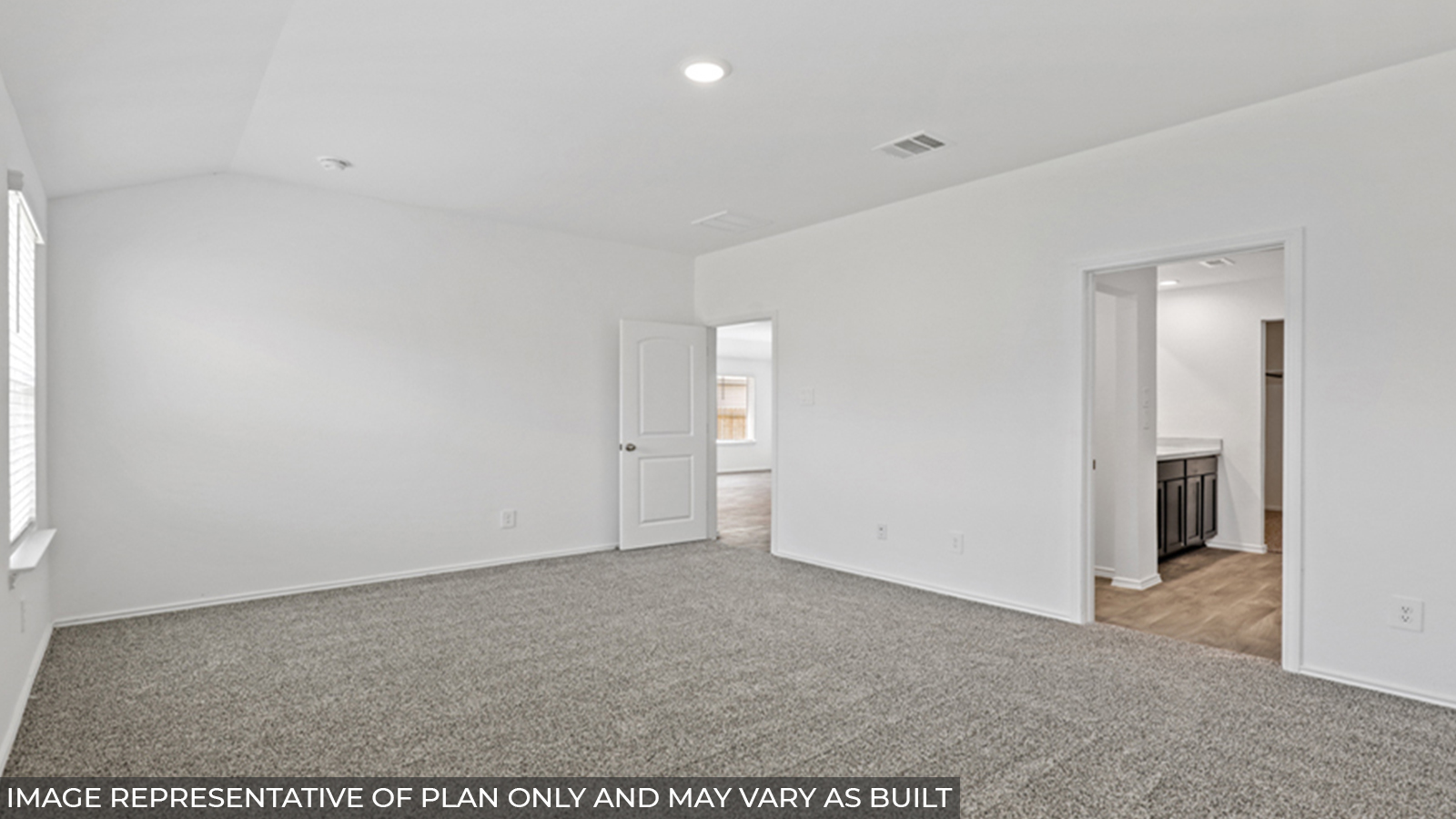 Primary bedroom with carpet flooring