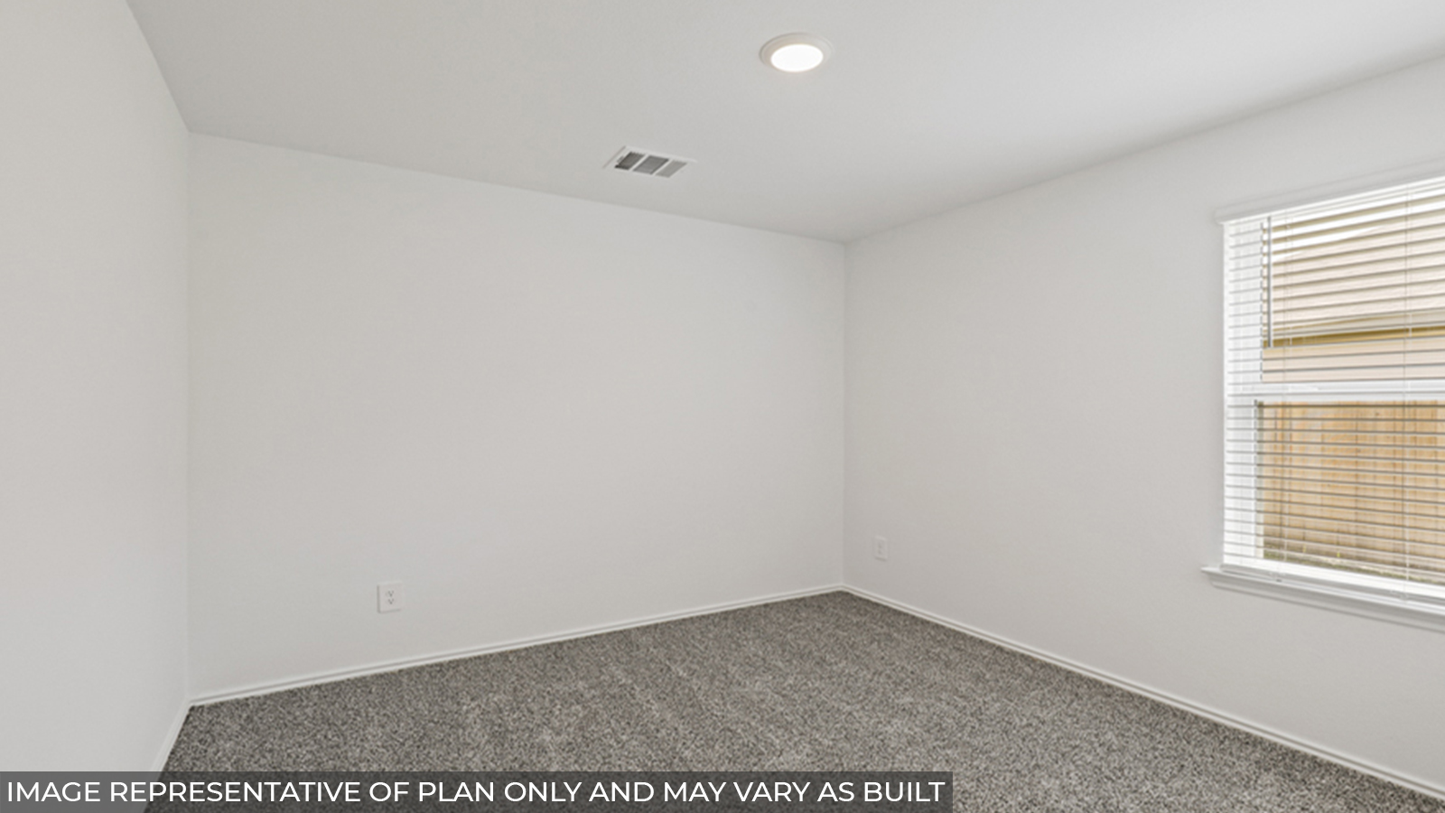 Secondary bedroom with carpet flooring