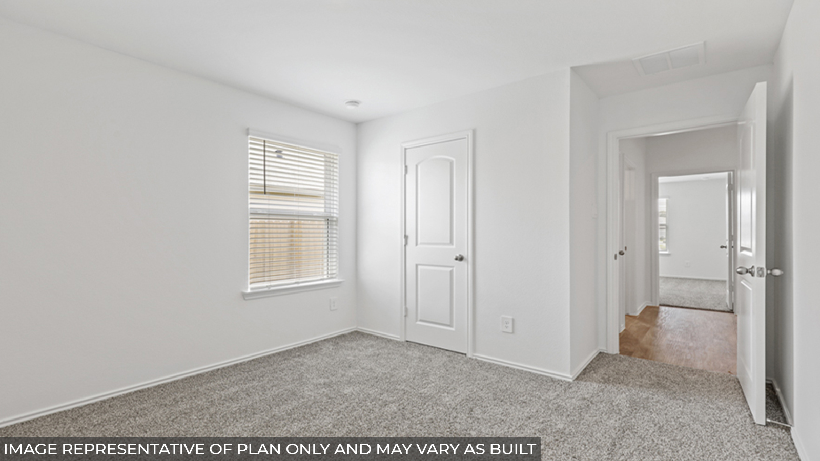 Secondary bedroom with carpet flooring