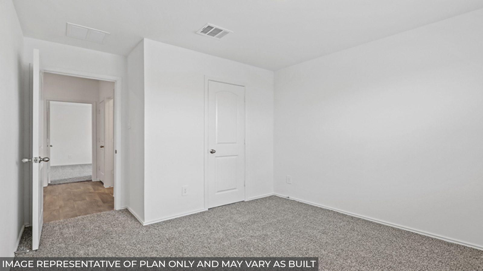 Secondary bedroom with carpet flooring