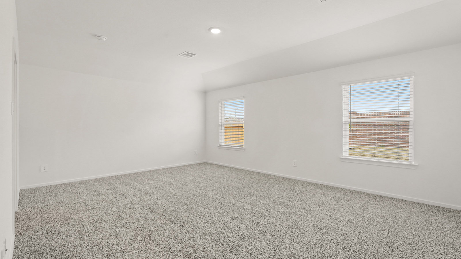 Primary bedroom with bright windows