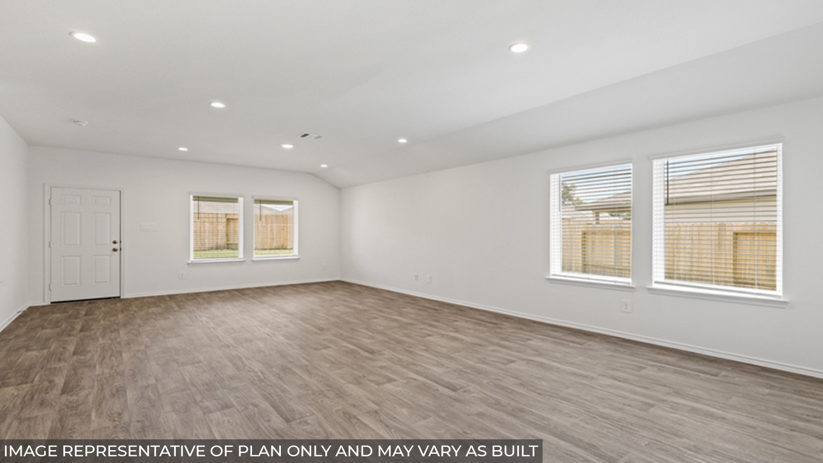 Open concept living and dining space with vinyl flooring and bright windows.