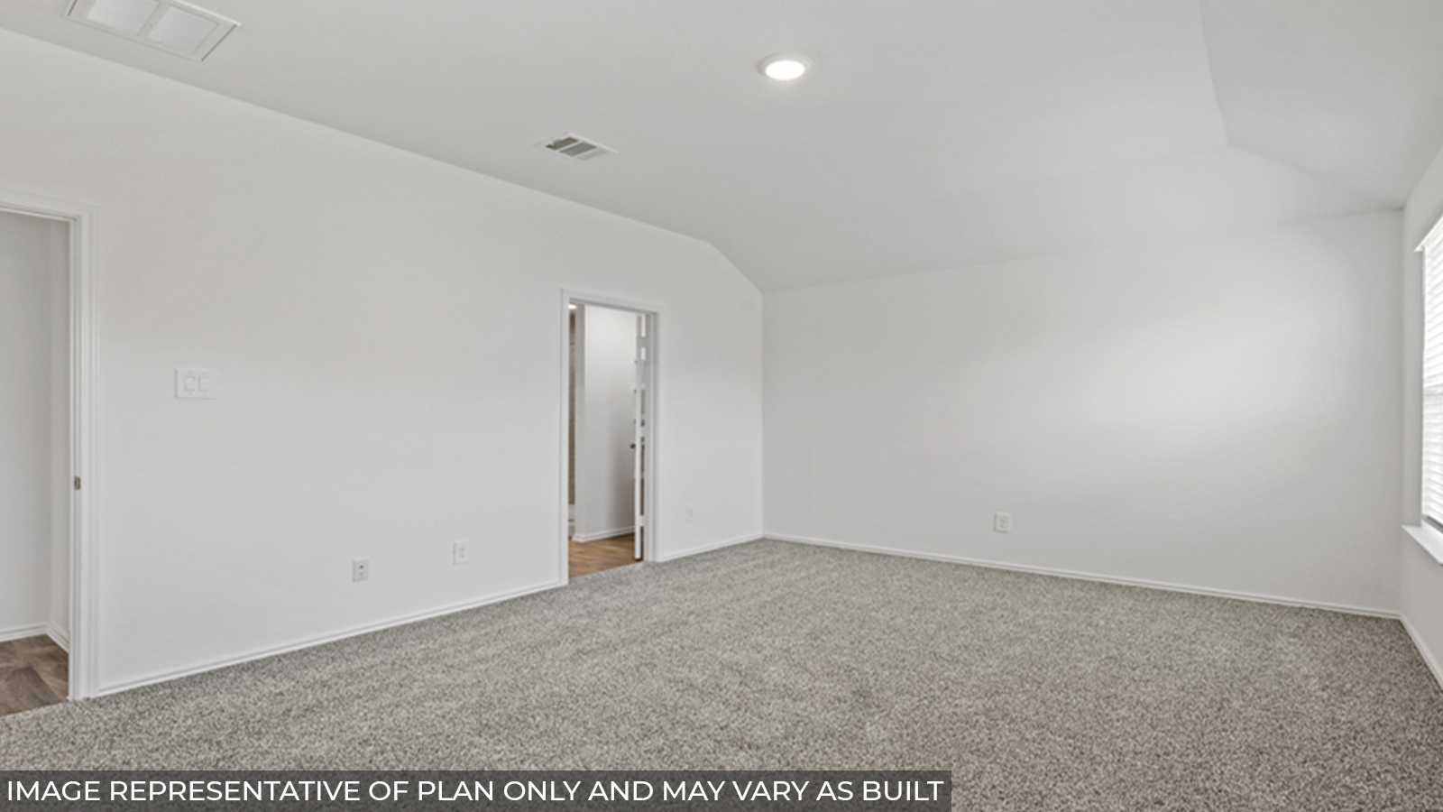 Primary bedroom with carpet flooring.