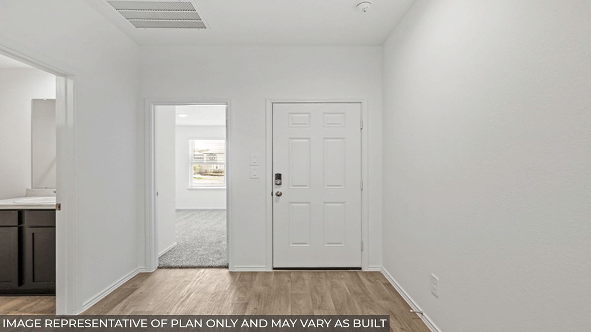 Entryway and foyer with vinyl flooring.