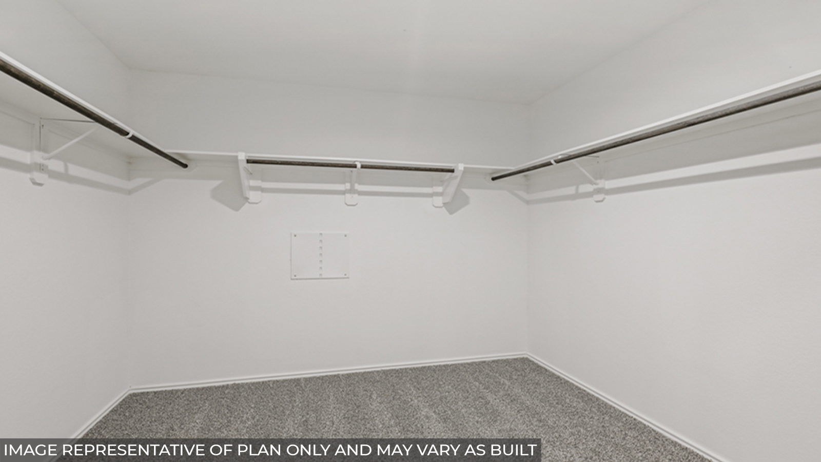 Primary bedroom walk-in closet with carpet flooring and overhead storage space.